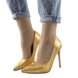 Audreys goldene schillernde Absätze