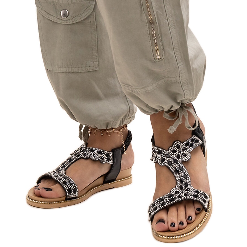 Shahidas glänzende schwarze Sandalen