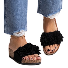 Schwarze Flip-Flops mit Blumen auf der Apolonia-Plattform