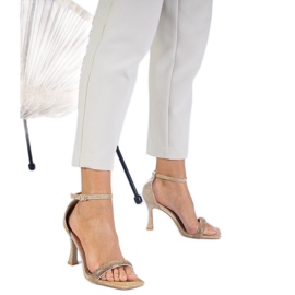 Golden elegante Sandalen auf einem mit Zirkonen dekorierten High Heel