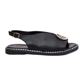 Flache elegante Sandalen mit einer schwarzen Dekoration