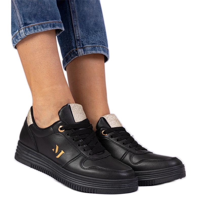 Schwarze Frauen -Turnschuhe mit goldenem Glitzer