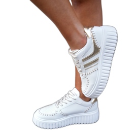 Frauen -Turnschuhe auf der Goldplattform golden