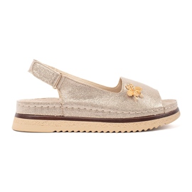 Goodin Goldsandalen auf der Plattform mit einem Stift golden