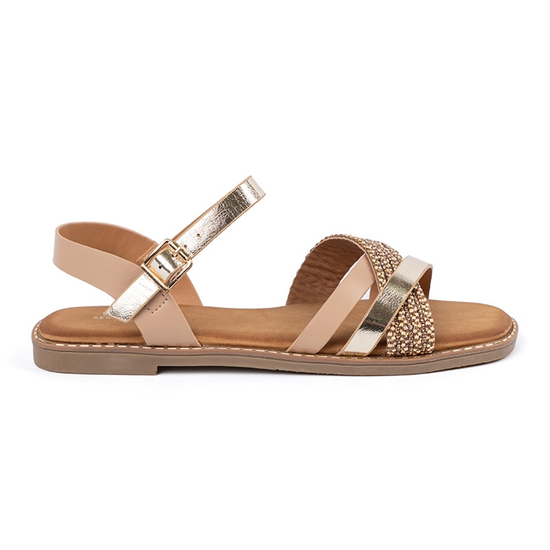 Goldene Frauensandalen auf einem flachen Sohle Sergio Leone