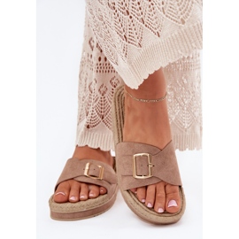Die Flip -Flops für Frauen auf der Plattform mit einer goldenen Klemme dunkler Beige