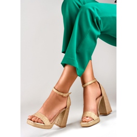 Goldglänzende Sandalen auf einem breiten hohen Absatz golden 1