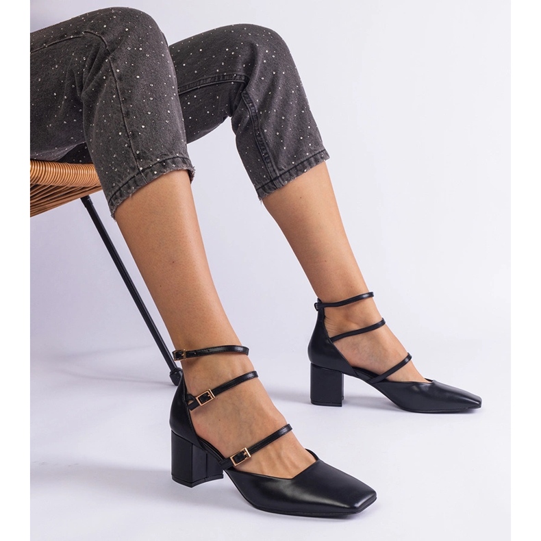 Schwarze Pumpen auf der Säule mit Schnallen 1