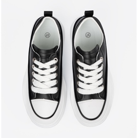 Schwarze und weiße Turnschuhe auf der Plattform 3