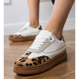 Weiße Turnschuhe mit einem Leopardenzubehör 3