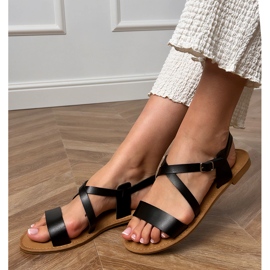 Schwarze flache Sandalen mit einem Gürtel 1