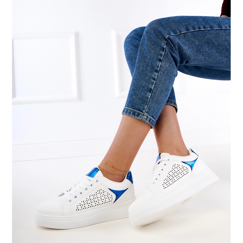 Weiße Turnschuhe mit blauen Einsätzen auf der Plattform 1