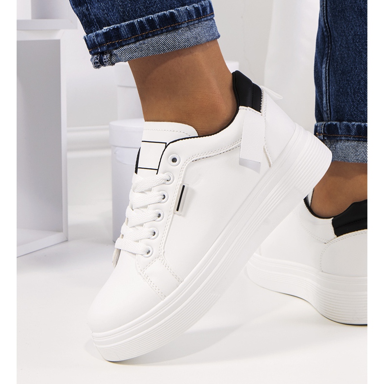 Weiße Turnschuhe auf der Perales-Plattform 1